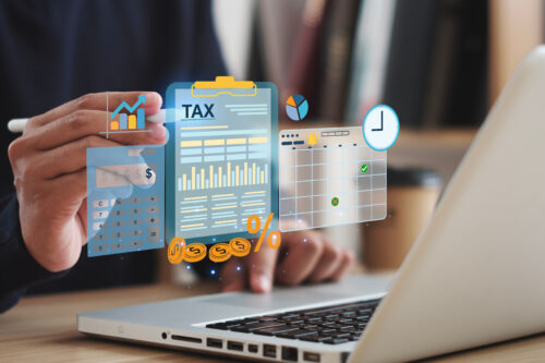 Tax concept. Person using computer to fill out personal income tax return to pay taxes online. State tax. Financial research. data analysis, documents, reports, tax returns, calculations.