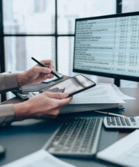 Investors working on desk office and use tablet to check tracki